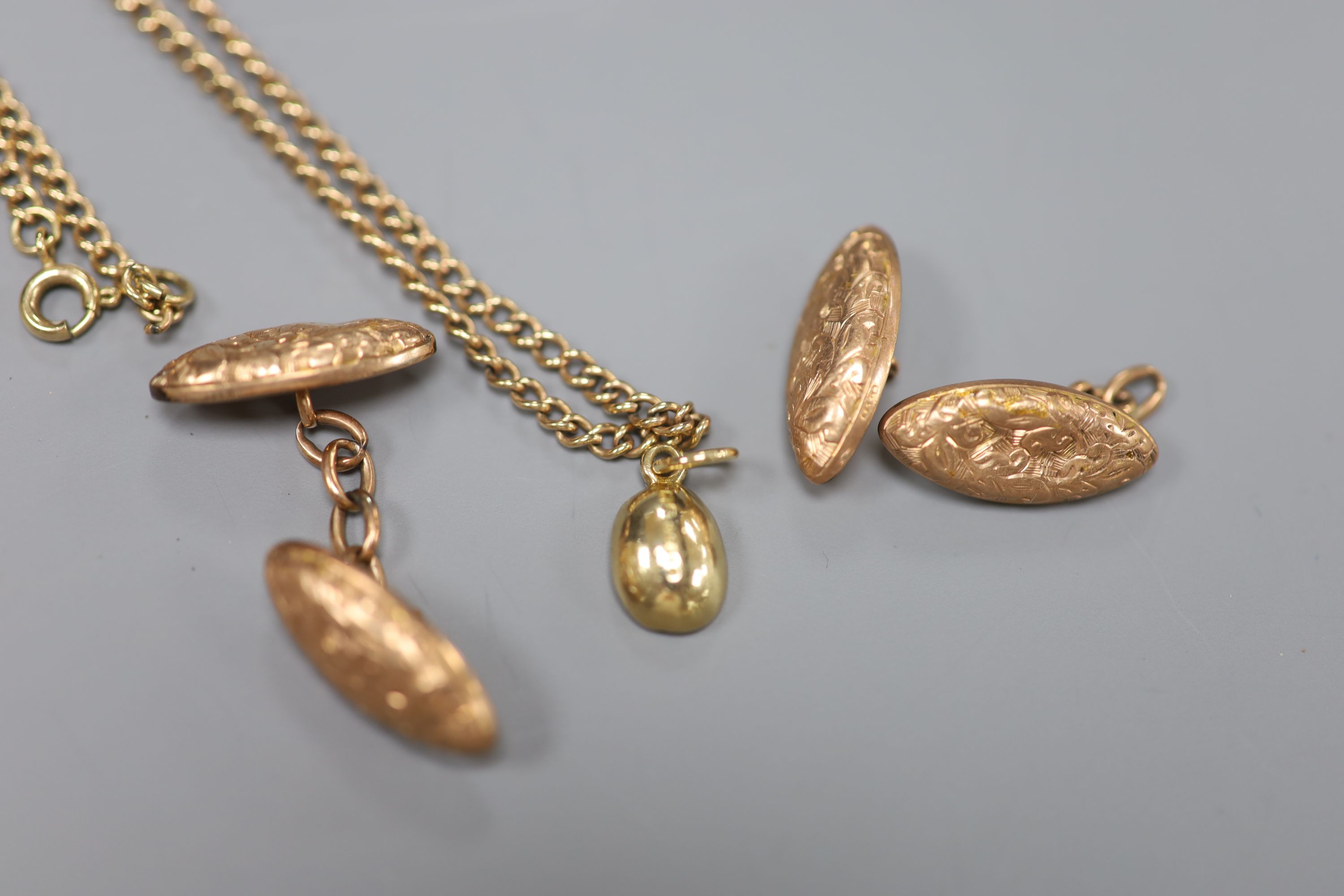 A pair of 9ct oval engraved gold cufflinks (one a.f.), a small 9ct gold bean pendant and a 9ct gold neck chain, gross 14.3g.